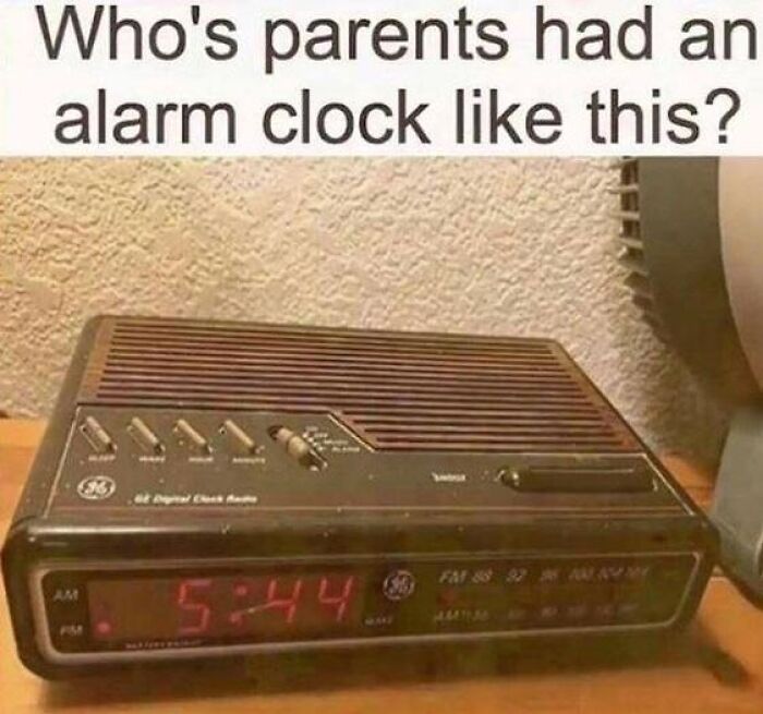 A vintage woodgrain GE digital clock radio showing 5:44, evoking nostalgic memories of retro electronics.