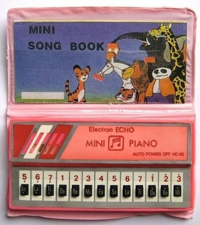 A nostalgic Electron Echo pink mini piano toy with its songbook from the 80s or 90s