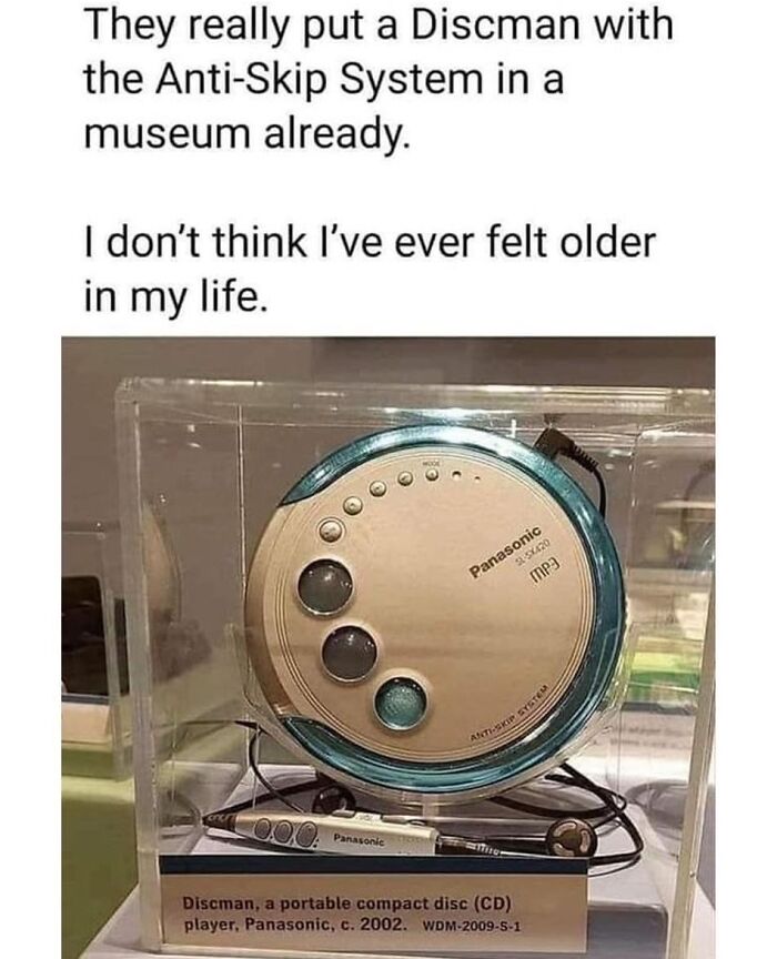 A vintage Panasonic Discman CD player displayed in a museum case evoking nostalgic tech memories