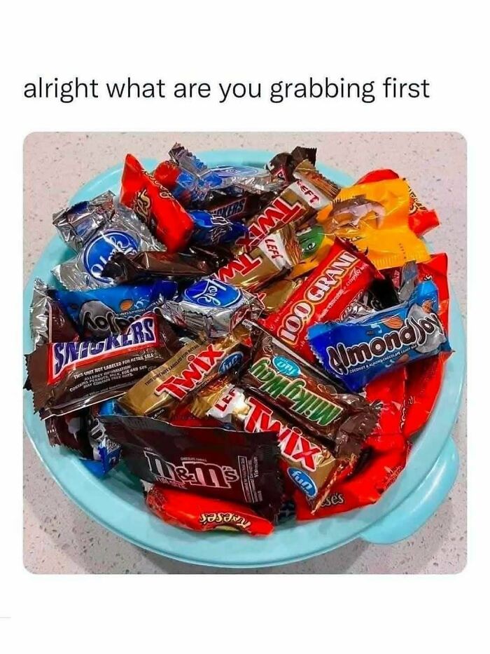 A bowl filled with assorted Halloween chocolate candies as part of spooky season memes