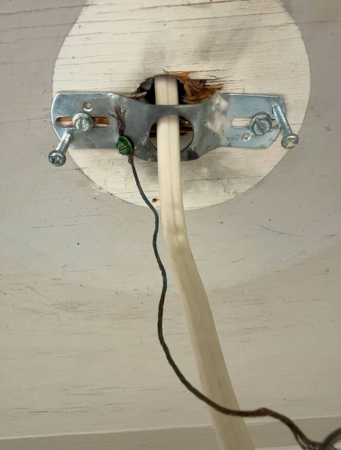 Close-up of a poorly executed ceiling light electrical wiring DIY project.