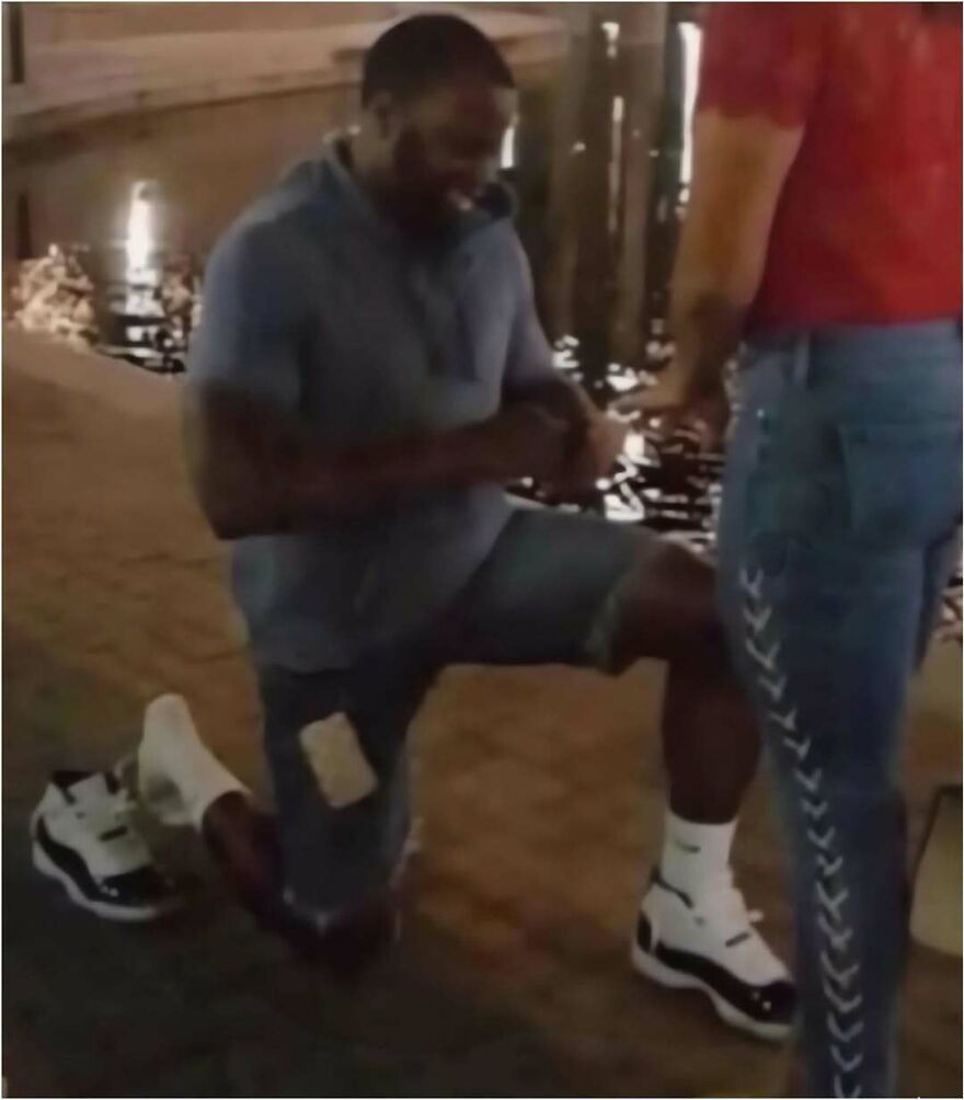 A man proposing on one knee with a shoe removed, featured in a collection of hilarious out-of-context pics.