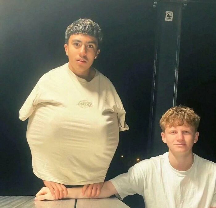 Hilarious pics of a guy tucking his hands inside a stretched shirt creating a funny shape with his friend nearby