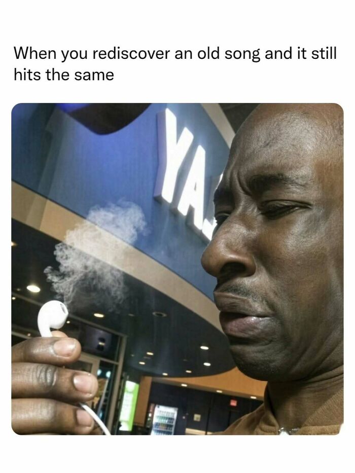 A man reacting to listening to music on smoking earphones, a relatable image when sending memes to friends.