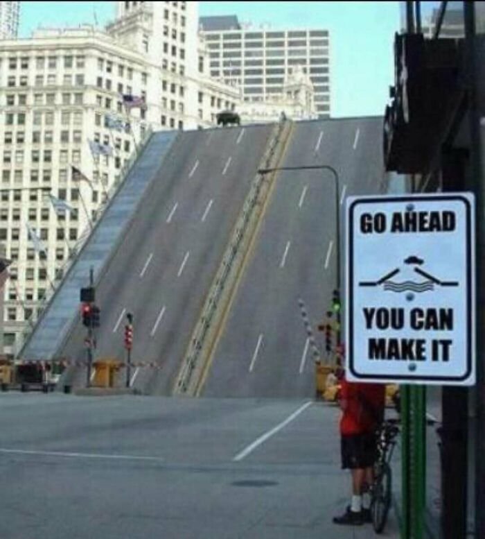 Bridge raised with sign encouraging to go ahead and you can make it