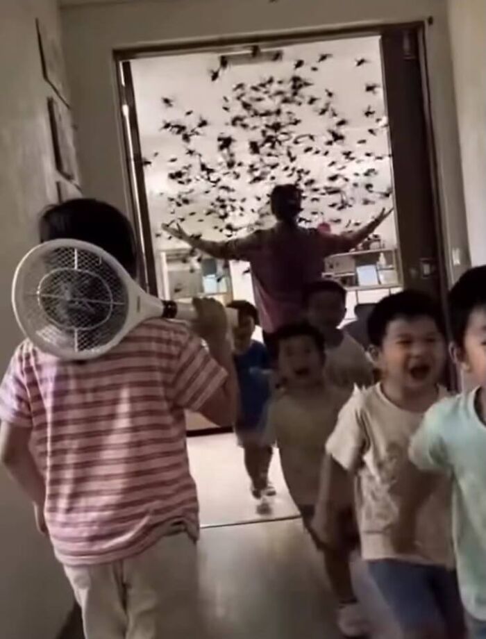 Hilarious pics of kids running with electric fly swatters from a swarm of insects