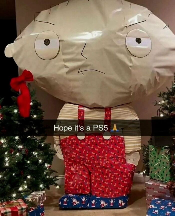 Hilarious pics of a Christmas present wrapped like Stewie Griffin next to a tree.
