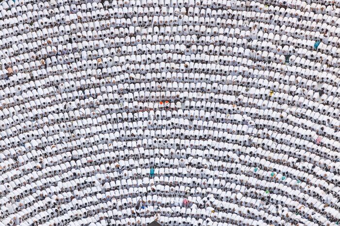 Aerial view of large crowd in uniform white clothing best pics 2026