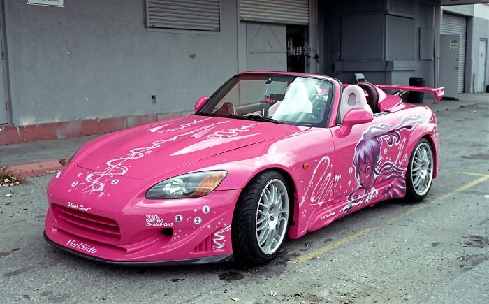 The iconic pink Honda S2000 movie prop car parked outside a studio