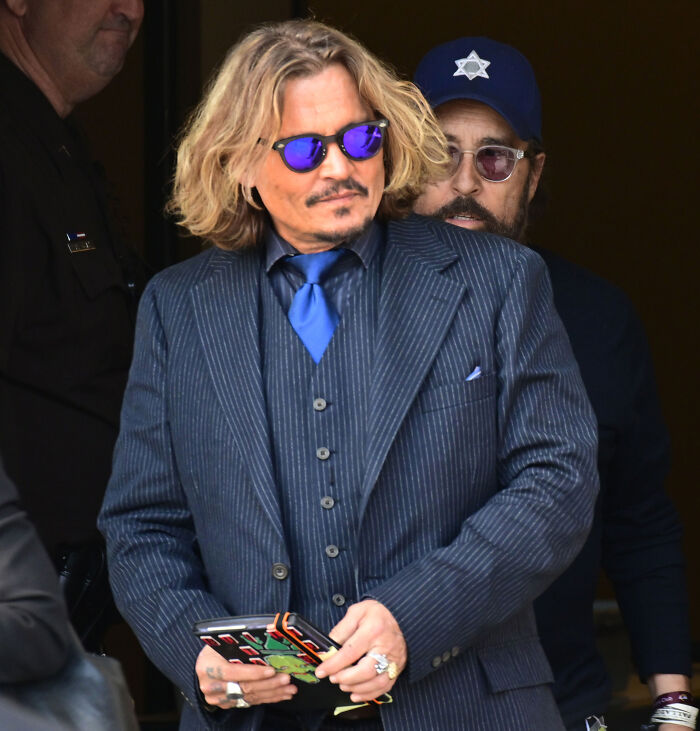 Johnny Depp wearing a pinstripe suit and sunglasses at court during the Amber Heard lawsuit
