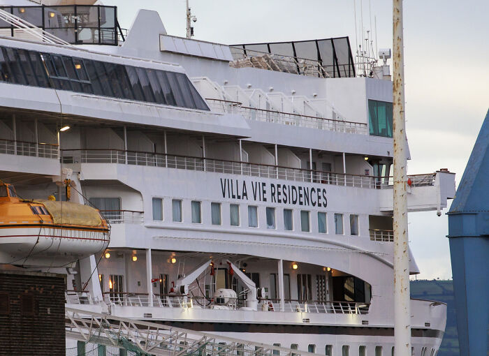 Side view of the Villa Vie Residences permanent cruise ship docked at port Side view of the Villa Vie Residences permanent cruise ship docked at port