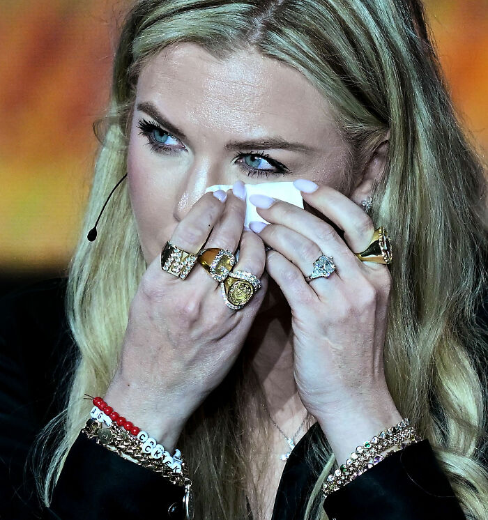 Close-up of Erika Kirk wiping away tears while showcasing her rings and bracelets. Close-up of Erika Kirk wiping away tears while showcasing her rings and bracelets.
