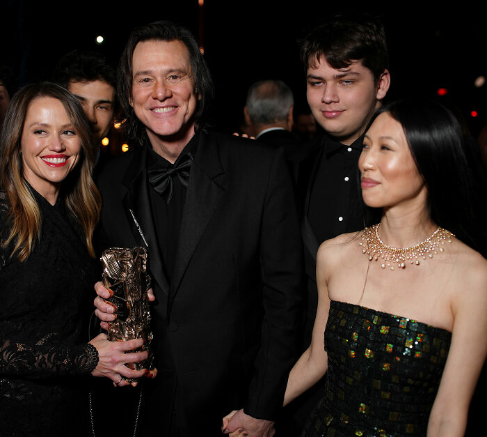 Jim Carrey holds hands with girlfriend Min Ah as they pose with others at an awards ceremony. Jim Carrey holds hands with girlfriend Min Ah as they pose with others at an awards ceremony.