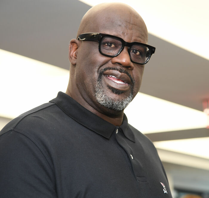Portrait of Shaquille O'Neal wearing black glasses and polo shirt Portrait of Shaquille O'Neal wearing black glasses and polo shirt