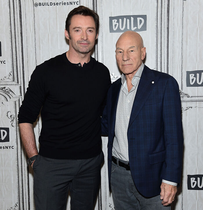 Patrick Stewart standing alongside Hugh Jackman at a promotional event. Patrick Stewart standing alongside Hugh Jackman at a promotional event.