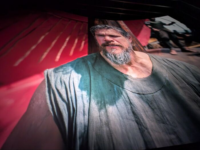 Distorted screen showing a broad bearded man in an absurdly stretched image format