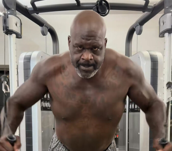 Shaquille O'Neal shirtless working out at gym with cable machine Shaquille O'Neal shirtless working out at gym with cable machine
