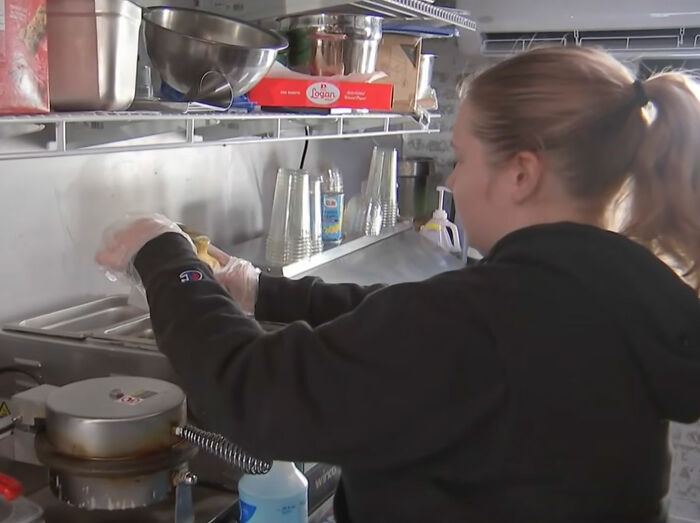 An ice cream shop employee working in the kitchen. An ice cream shop employee working in the kitchen.