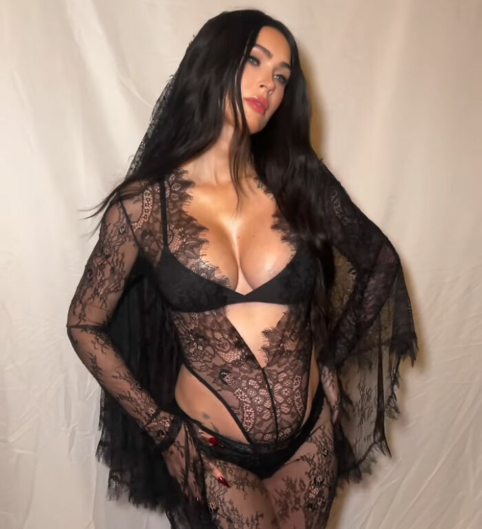 Megan Fox posing in a black lace outfit and veil Megan Fox posing in a black lace outfit and veil