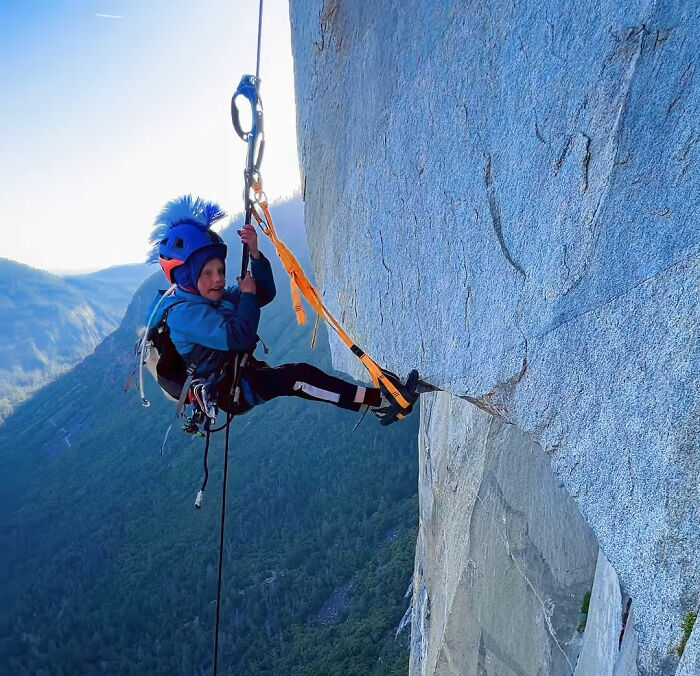 A 7-year-old boy climbing Yosemite's El Capitan on a steep granite cliff face