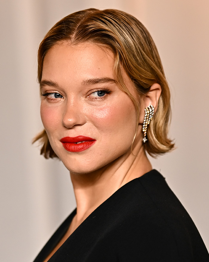 Unedited photos of Lea Seydoux posing with red lipstick at the Academy Museum Gala.