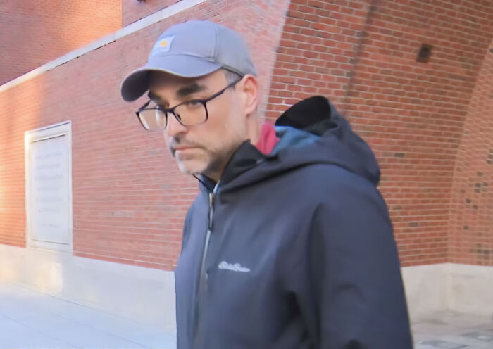 Dad wearing a cap and glasses walking outside after committing an alarming crime mid-flight