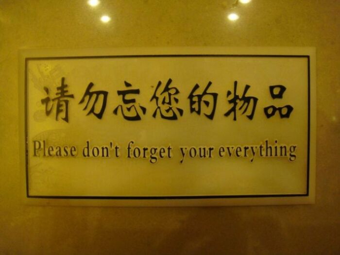 A sign with translation fails stating Please don't forget your everything in English and Chinese