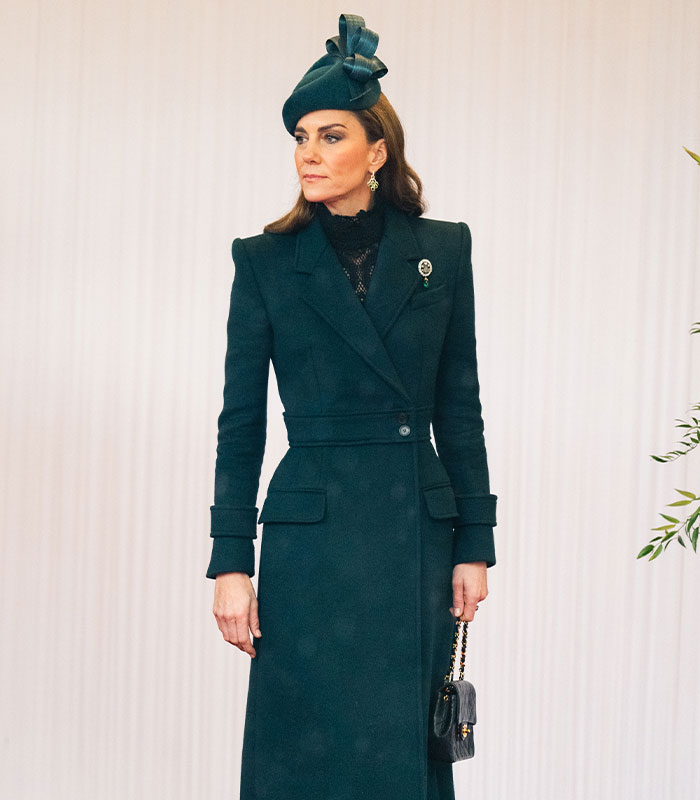Kate Middleton wearing a dark teal tailored coat and matching fascinator at a royal event
