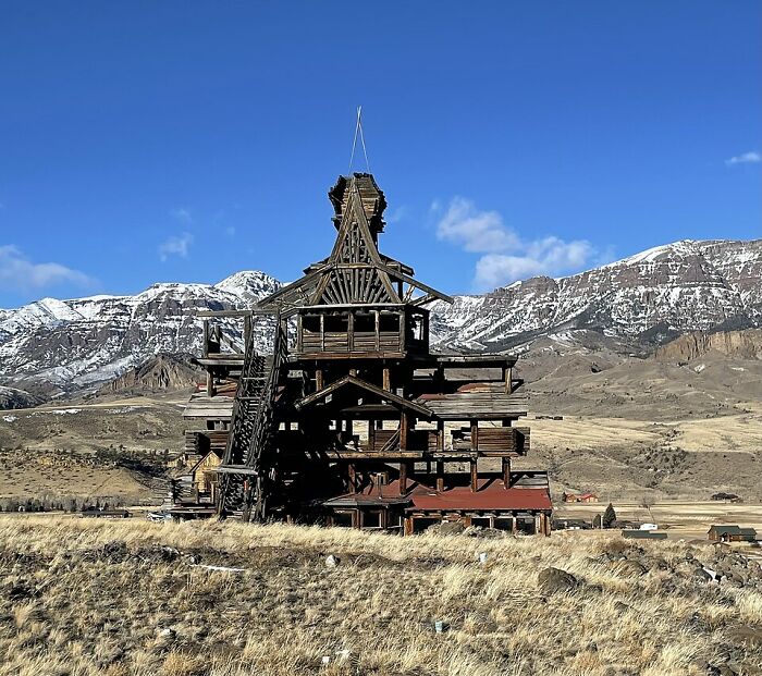 Unusual wooden building with complex structure in mountainous landscape