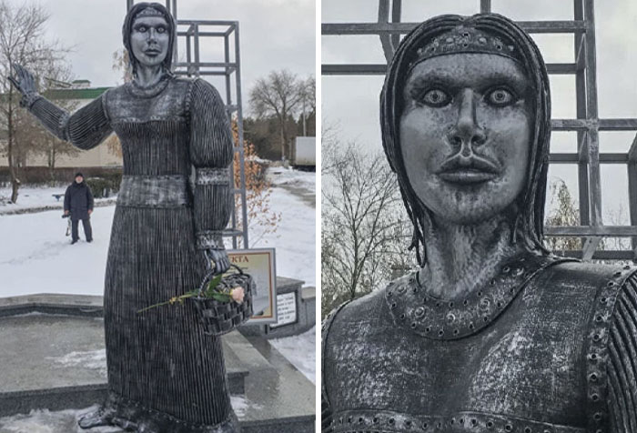 A creepy and bizarre public art statue of a woman with wide, staring eyes holding a flower basket in winter