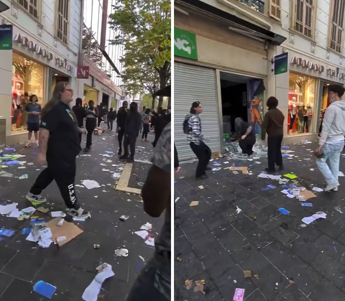 Crowded street outside store littered with papers during France riots
