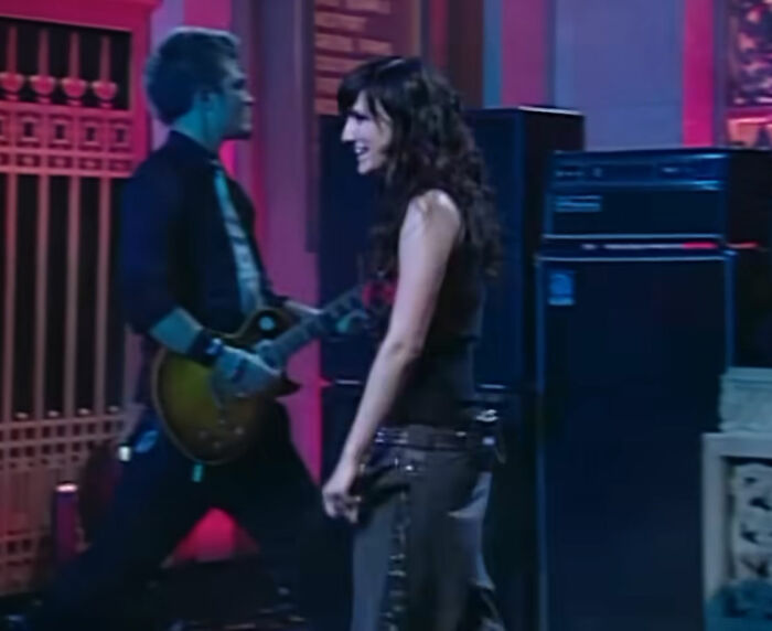 Ashlee Simpson performing on stage with a guitarist, representing stars in live music moments.