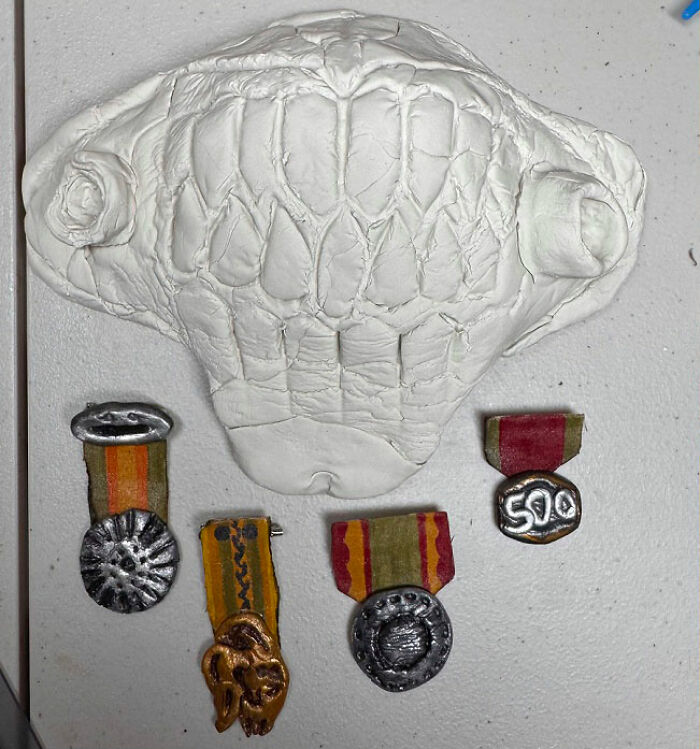An unpainted clay Immortan Joe mask and small medals for a Mad Max Furry Road photoshoot. An unpainted clay Immortan Joe mask and small medals for a Mad Max Furry Road photoshoot.