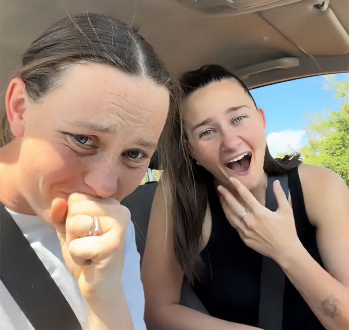 Two shocked women in a car reacting to a bizarre voice message after a man stands woman up on first date.