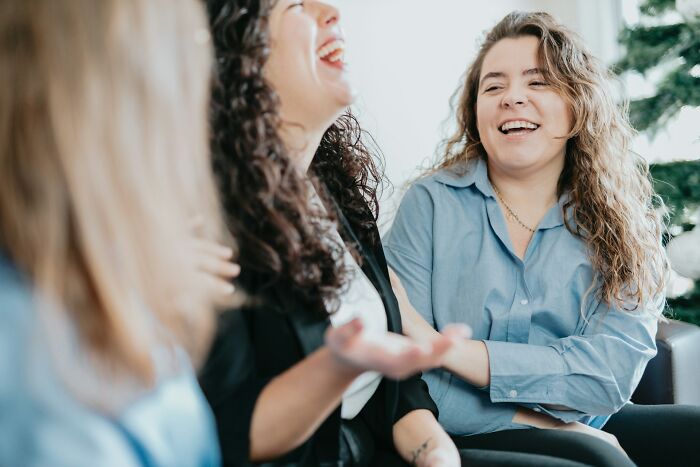 A group of women sharing a laugh as they point out behaviors they refuse to tolerate
