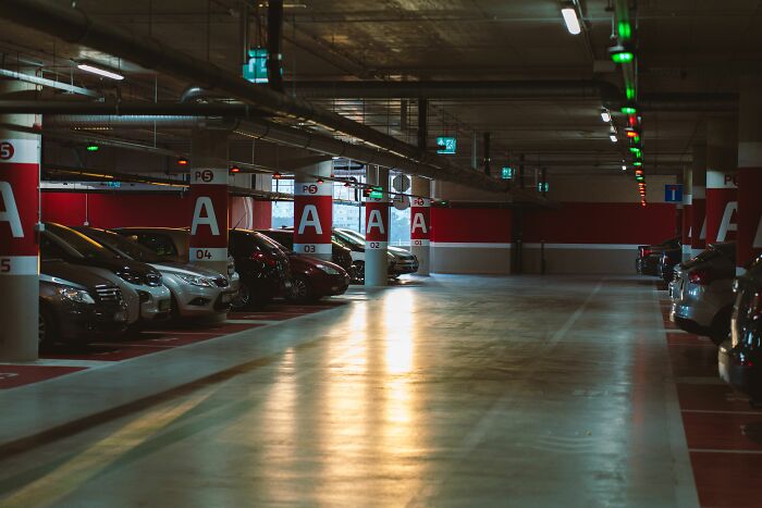 A dimly lit underground parking garage where secrets might be whispered