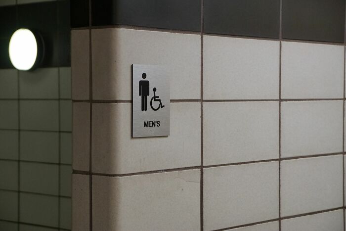 A closeup of a men's restroom sign, highlighting secrets by accident in everyday places