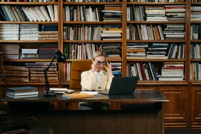 A researcher looking at a screen in a library, finding secrets by accident