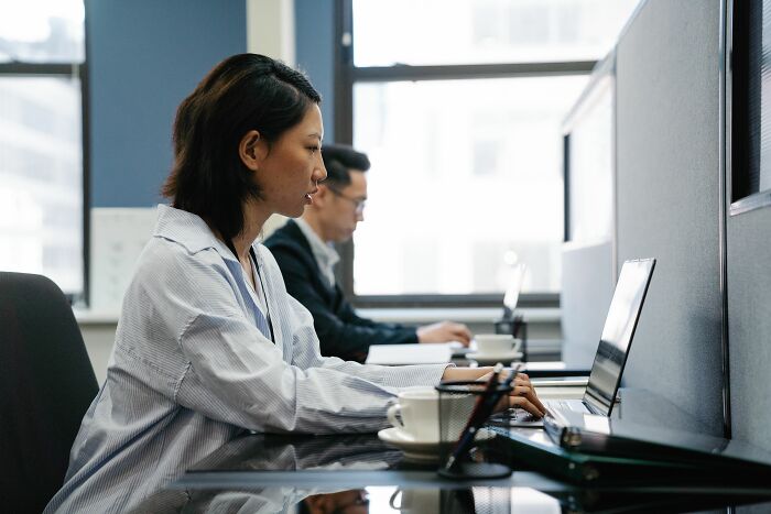 A woman working on a laptop at her desk, finding secrets by accident online