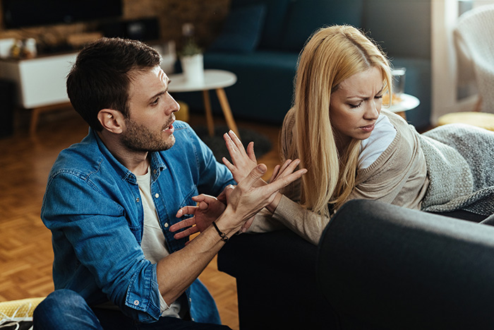 A man trying to talk to an upset woman, illustrating conflict with an ex-husband. A man trying to talk to an upset woman, illustrating conflict with an ex-husband.