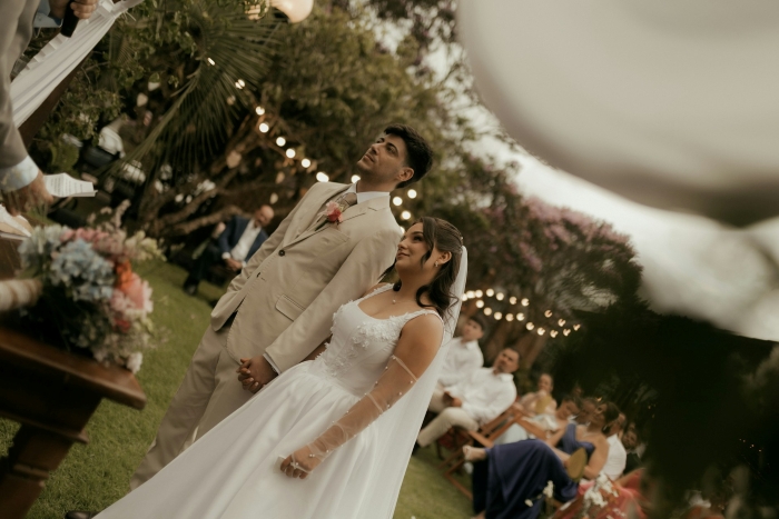 A bride and groom standing together during an outdoor ceremony for a SIL wedding. A bride and groom standing together during an outdoor ceremony for a SIL wedding.
