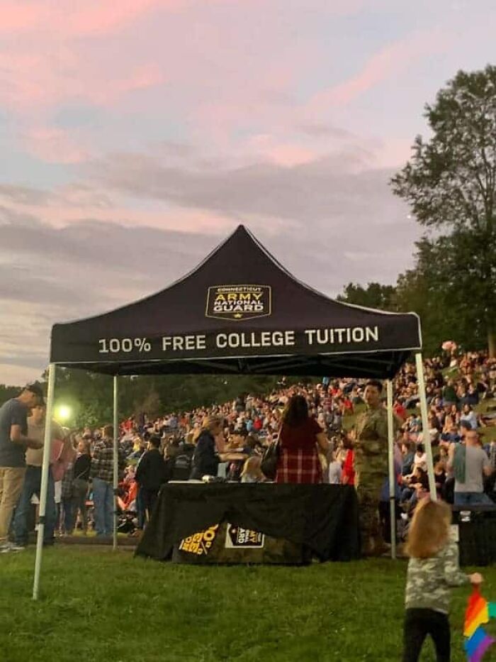 A military recruitment tent offering free college tuition as a solution in modern life in America