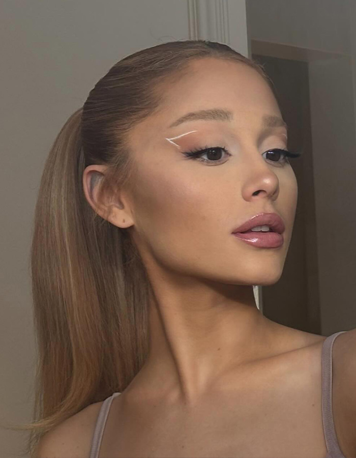 Ariana Grande showing off a sleek hairstyle and graphic eyeliner after her hair transformation.