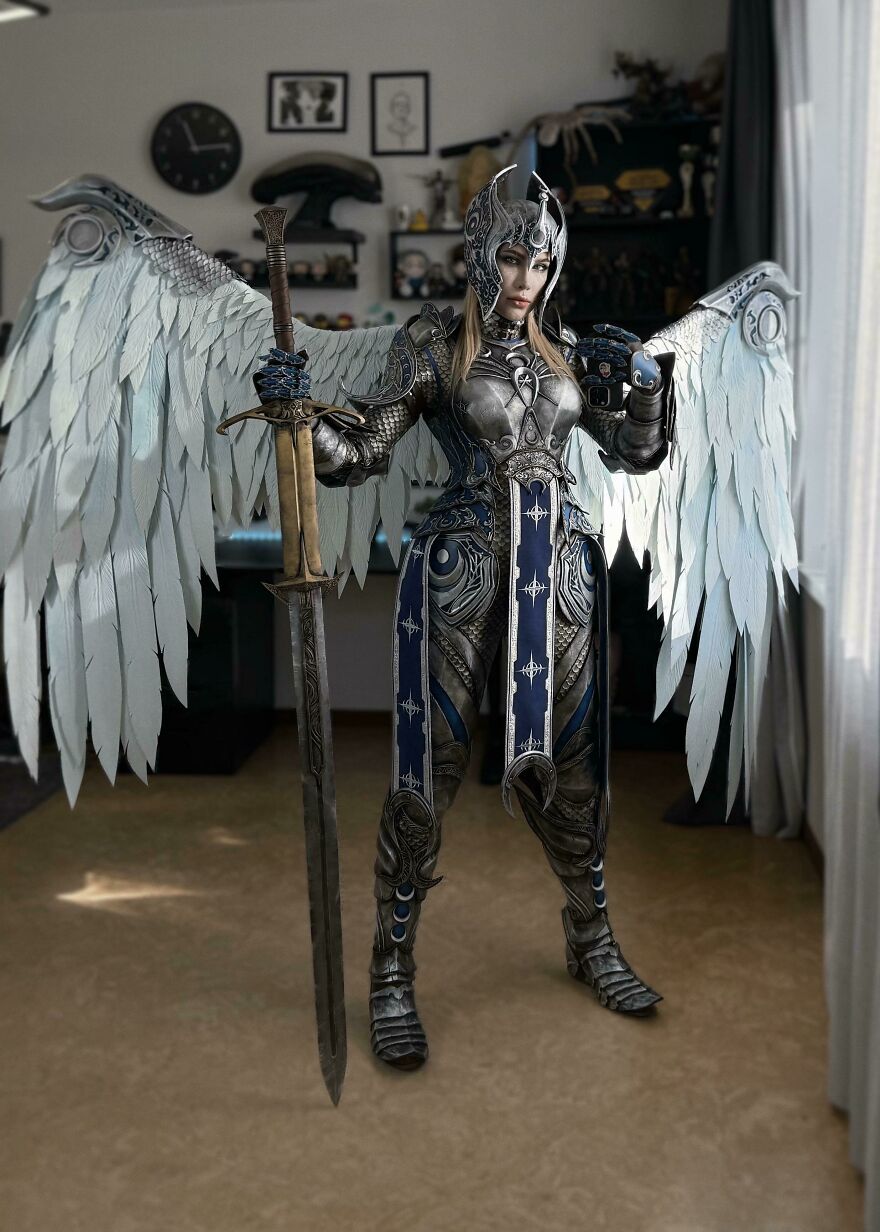 An elaborate full-body armored angel cosplay with large white wings as a creative Halloween costume idea.