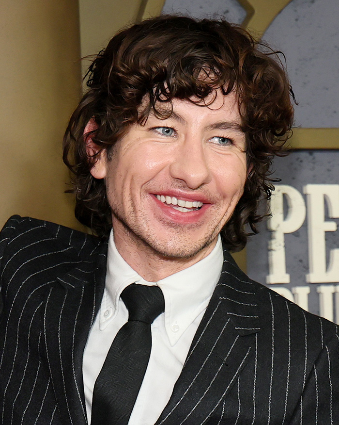 Barry Keoghan smiling on the red carpet following news of his cosmetic procedure.