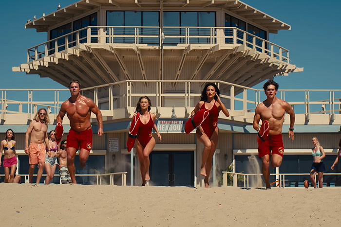Promo picture of lifeguards running on the beach for a Hollywood TV reboot