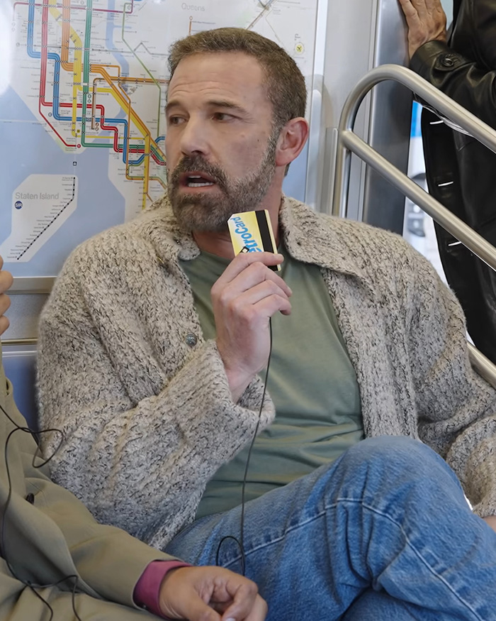 Ben Affleck holding microphone on subway, portraying problematic history with women