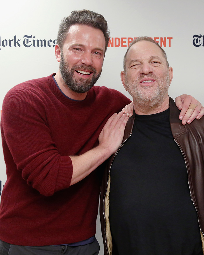Ben Affleck posing with another man at New York Times event