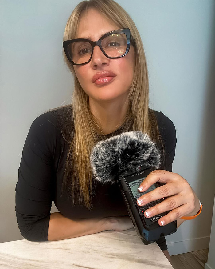 Woman holding recording device with furry microphone cover