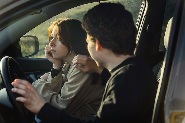 A man talking to his bestie in a car, looking tense. A man talking to his bestie in a car, looking tense.